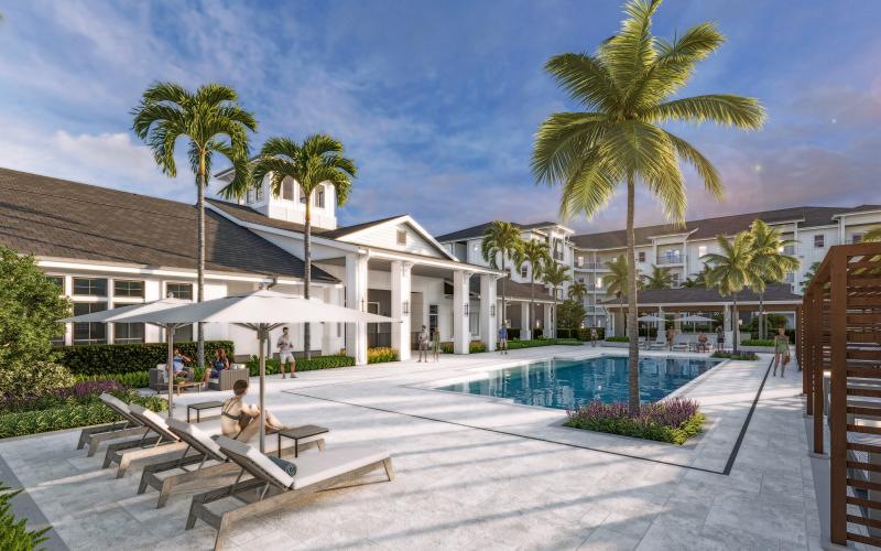 a swimming pool with palm trees and a building in the background