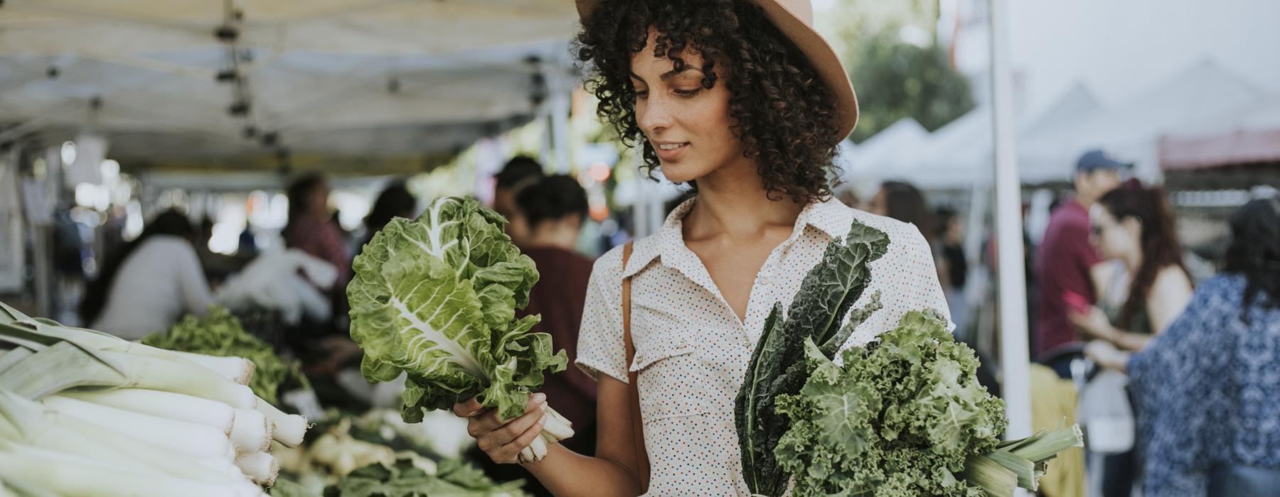 a person holding a bunch of broccoli