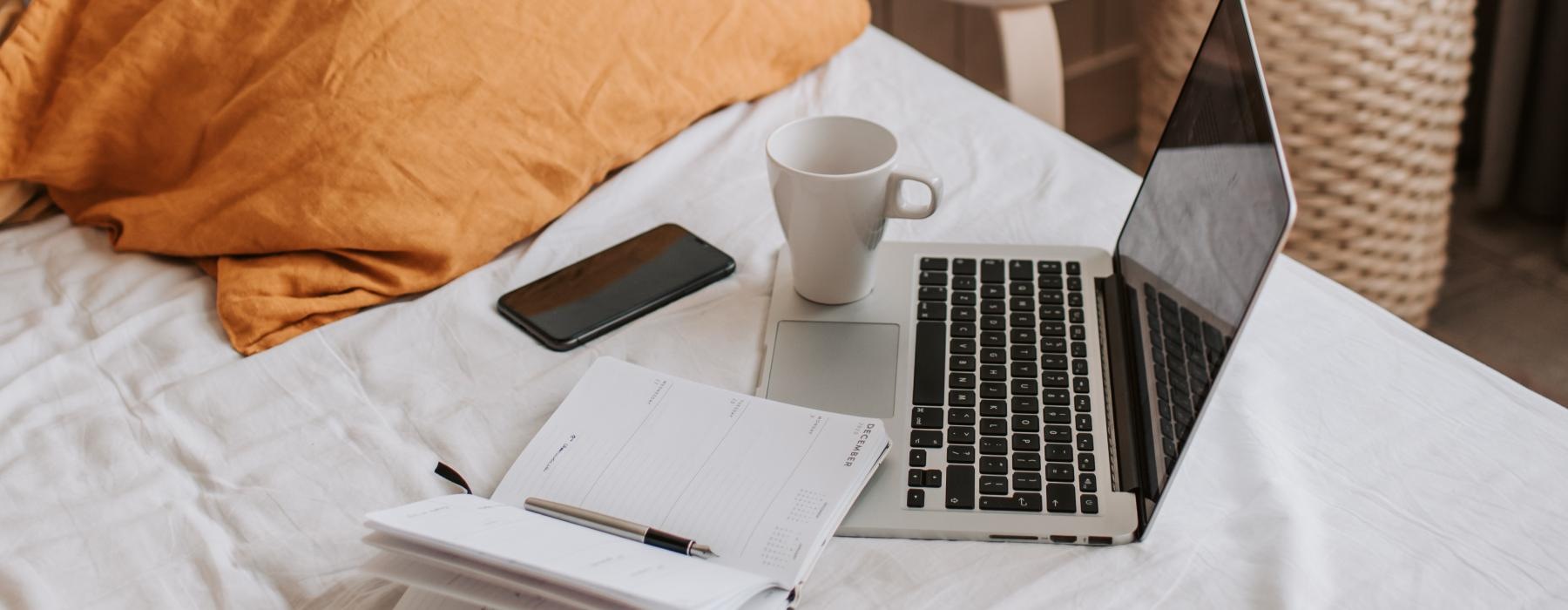 a laptop on a bed