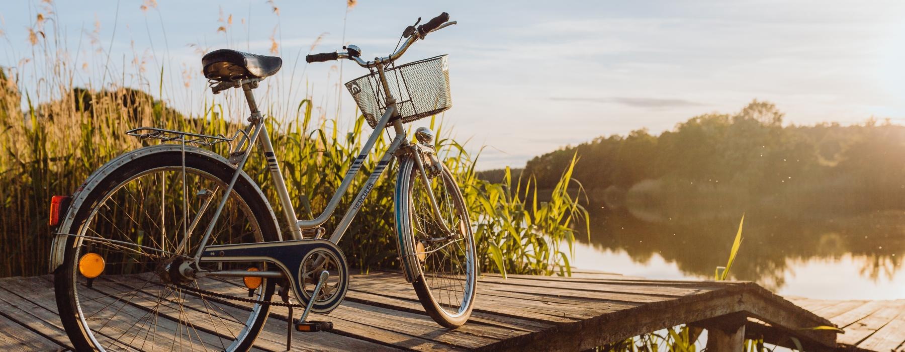 a bicycle parked on a wooden bridge